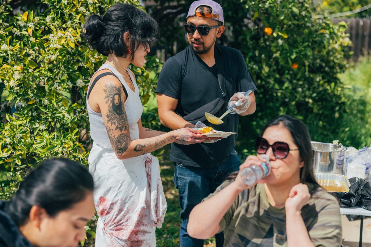 Guests enjoying pizza at an outdoor event